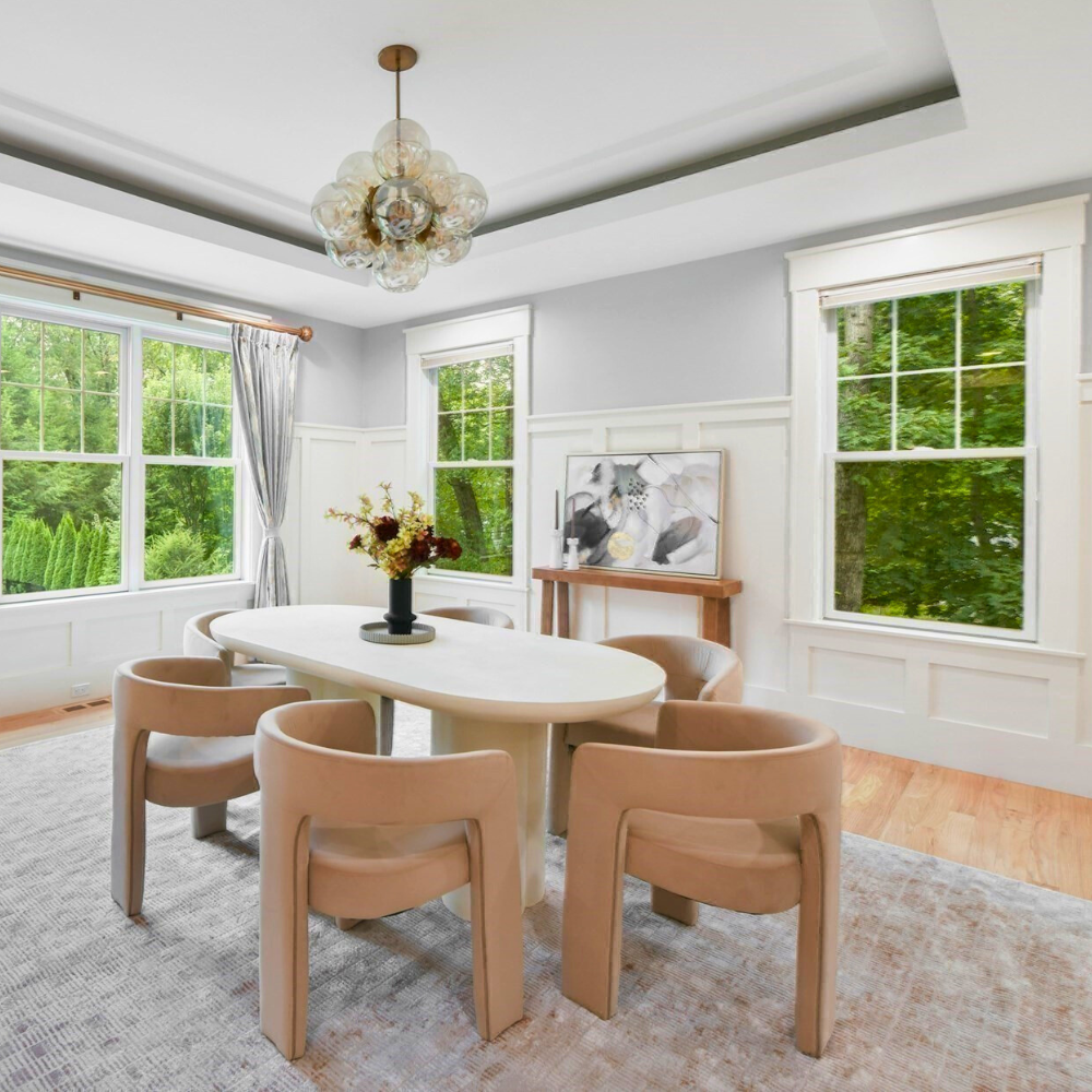 Dining room with windows and luxury staging in Wellesley, MA. 